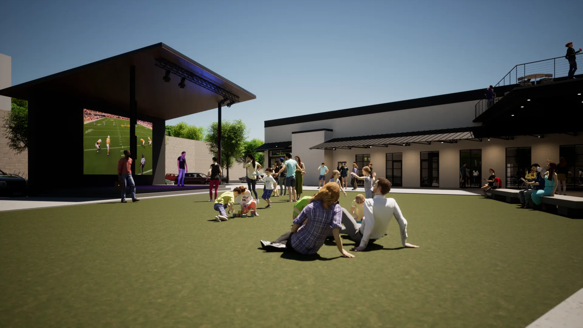 A simulated event lawn at Kern&rsquo;s Food Hall — families on the grass in front of a large LED screen, with a second-story porch overlooking it