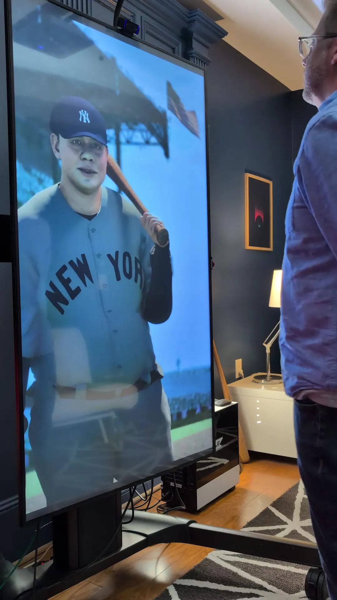 A visitor talking to Anvil running on a full-height portrait display