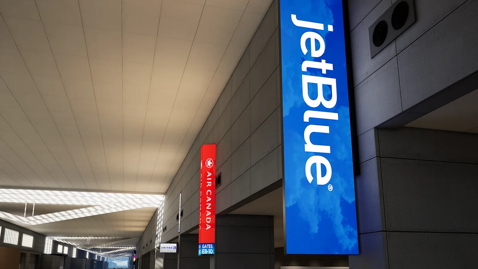 Simulated airport ticketing hall: airline identity columns mounted above the check-in rows, seen down the length of the concourse