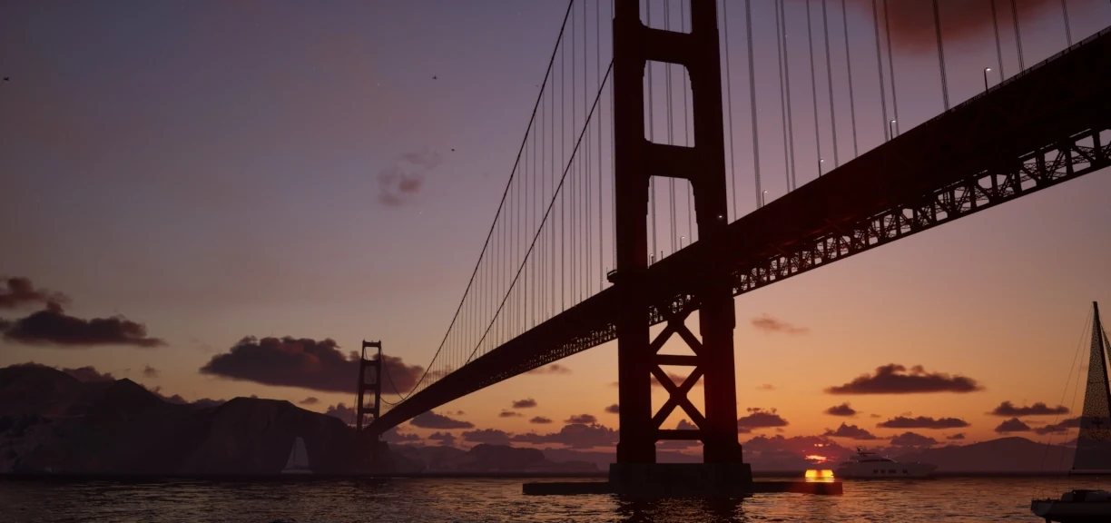 The Golden Gate Bridge at sunset, its tower silhouetted against an orange sky above the water
